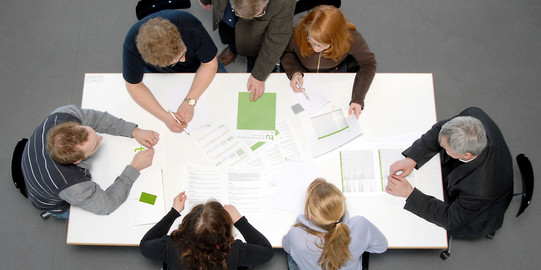 five students and a professor sitting aroung a table